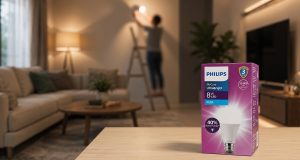 Kotak kemasan lampu philips UltraBright dengan latar belakang orang sedang memasang lampu